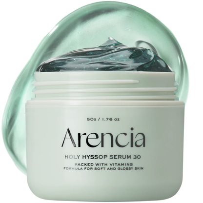 Skincare jar labeled 'Arenicia' with a green lid on a white background