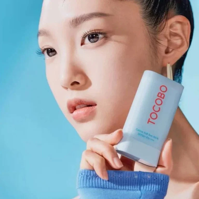 Person holding a TOCOBO product against a blue background