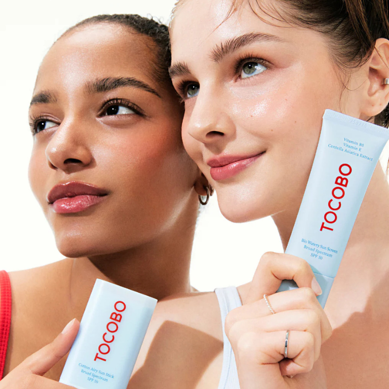 Two women holding Tocobo skincare products against a white background