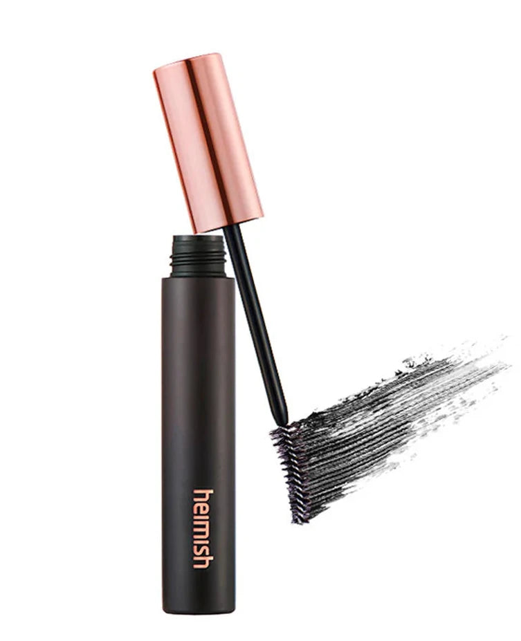 Black mascara with rose gold cap on a white background
