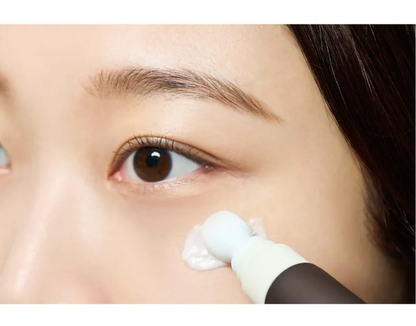 Close-up of a person applying cream to their face with a brush.