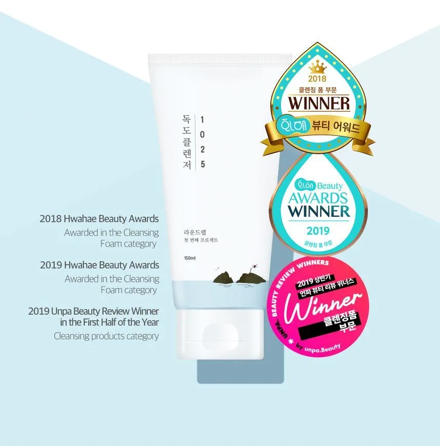 Cleansing product packaging with awards on a light blue background