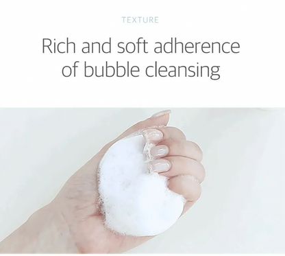 Hand holding a white cleansing pad with text 'Rich and soft adherence of bubble cleansing' on a light gray background