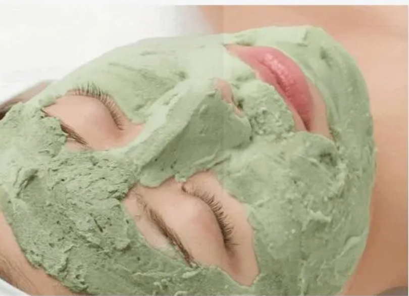 Person wearing a green facial mask with a close-up view of the face.