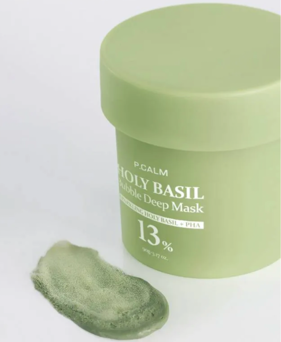 Green facial mask jar with a sample on a white background