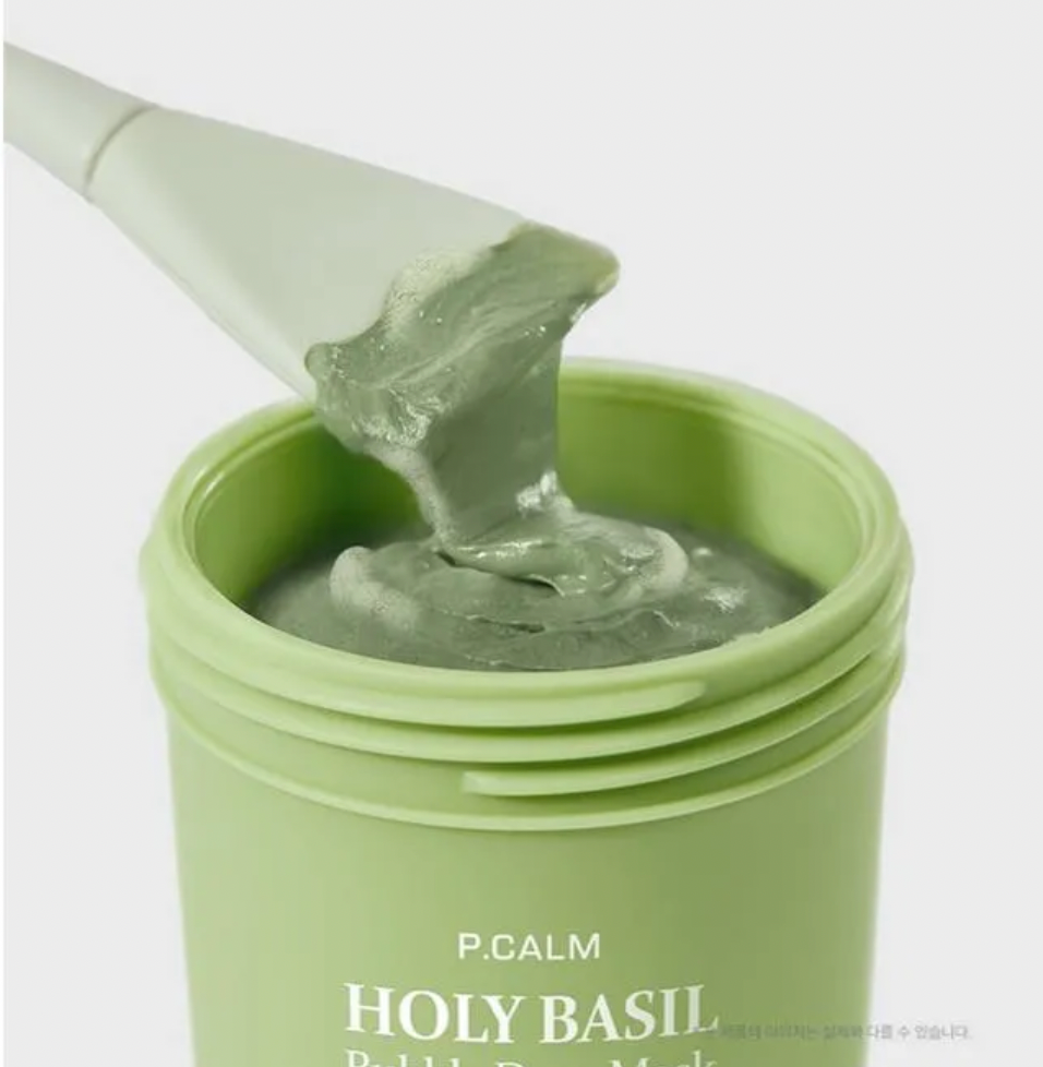 Green jar of P.CALM Holy Basil product with a spatula on a white background