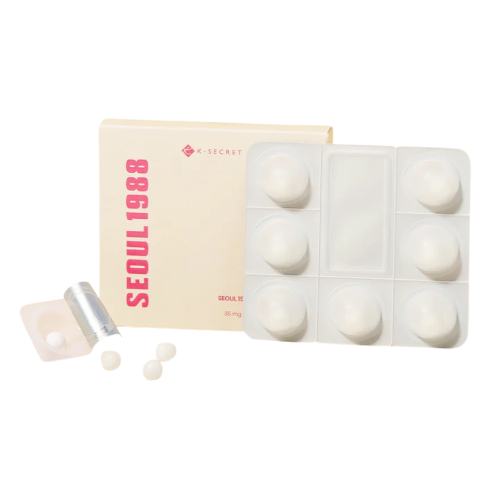 Boosting collagen product displayed in a yellow box with pink letters. The collagen boosters are round and in a small plastic  container. The background is white. 