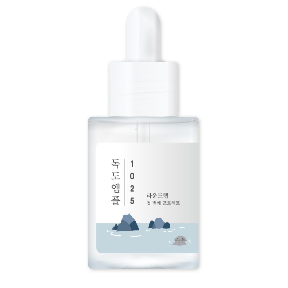 Skincare dropper bottle with a scenic label on a white background