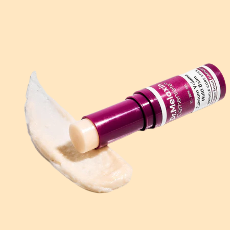 Dr. Maldon cosmetic stick with a smear of cream on a beige background