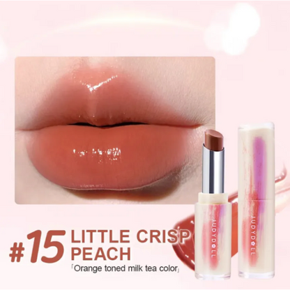 Lipstick with 'Little Crisp Peach' shade on a close-up of lips and product packaging.