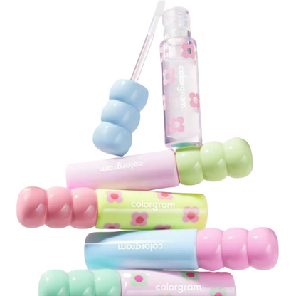 Colorful lip balm set with floral designs on a white background