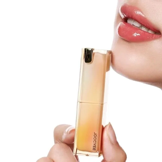 Lipstick held by a hand with a blurred background